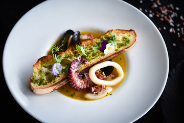 tasty seafood soup with fresh vegetables - shrimps, shells, octopus and crispy home made bread