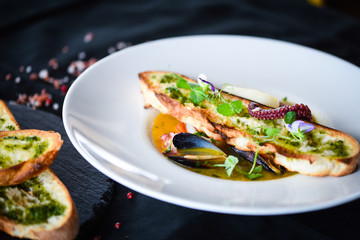 tasty seafood soup with fresh vegetables - shrimps, shells, octopus and crispy home made bread