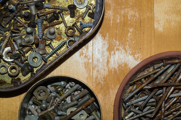 Old screws in a box. a lot of various screws. pile of fasteners in the box close up. carpentry workshop. working tool