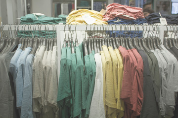 Blurred Bokeh Image of a Retail Clothing Store with hanging apparel for background