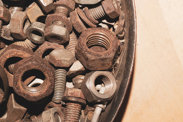 Old screws in a box. a lot of various bolts. pile of fasteners in the box close up. carpentry workshop. working tool