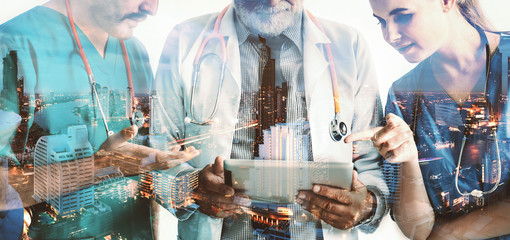 Double exposure group of doctor with tablet on night city background