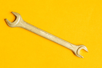 Wrench on yellow background with copy space. working tool