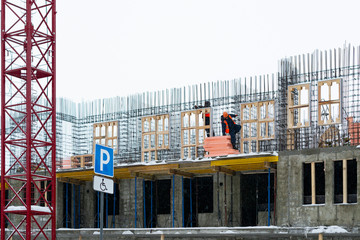 workers in orange workwear on construction site