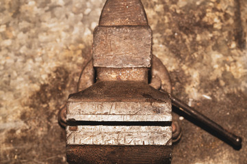 Old bench vise on a metal workbench. working tool