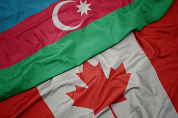 waving colorful flag of canada and national flag of azerbaijan.