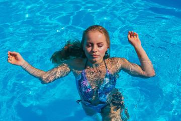 Fashion portrait of beautiful sexy young women in swimming pool