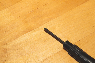 Screwdriver on a wooden table. working tool