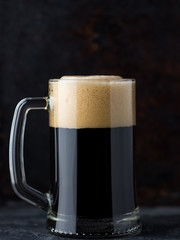 A mug of dark beer on a dark background