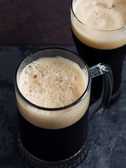 Two dark Beers in close-up . Mug and glass of beer