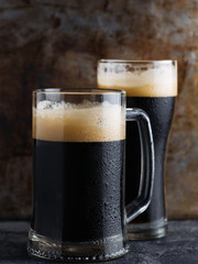 Two dark Beers in close-up . Mug and glass of beer