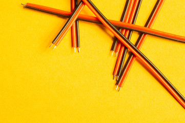 Fototapeta premium Colorful wires isolated on yellow background. connection wire for electrical schemes. copy space