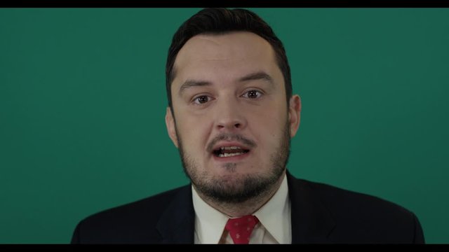 Man politics. Portrait of political fool giving a deceitful speech on camera isolated on green background. Shot with green screen background