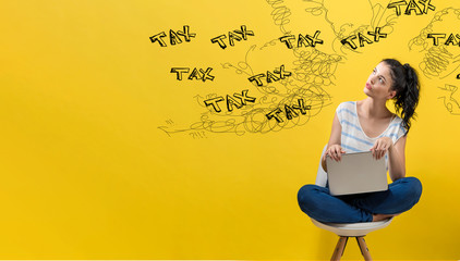 Tax problem theme with young woman using a laptop computer