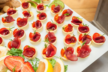 Prosciutto and rosemary with melted cheddar cheese Canape