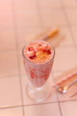 Milkshake in pink pastel sweet cafe concept on white table.