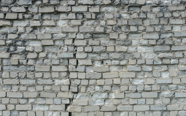Old cracked white brick wall