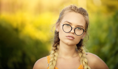 Attractive Blonde Young Woman With Natural Face Makeup Wearing Stylish Fashion Optical Eye Glasses. Copy space and summer autumn mood