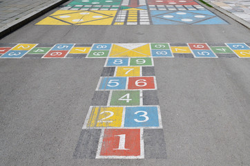 Fototapeta premium Hopscotch court with numbers from 1 to 9 drawn with paint on the asphalt