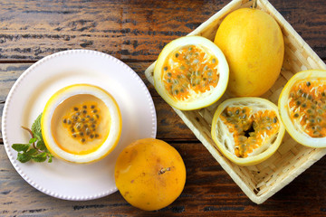 dessert passion fruit mousse in fruit rind on plate decorating rustic wooden table