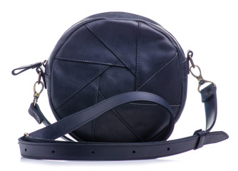 Female black round bag in hand on white background isolation