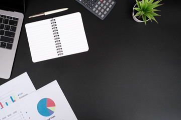 Top view office table desk with copy space laptop computer and supplies, Work space with black background, Flat lay