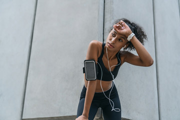 Fototapeta premium Female runner resting after intense training session outdoors