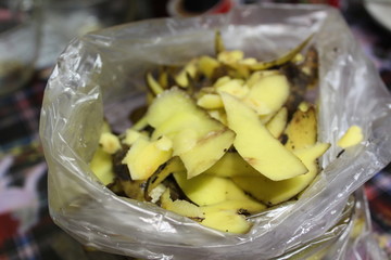 photo cleaning potatoes.potato peel.they're in a bag on the kitchen table.home cooking.cooking for lunch.