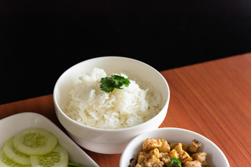 Thai cuisine, Northern of Thailand Lanna style, Hot steamed rice with crispy belly pork in chili flavor and fresh vegetables, space for text