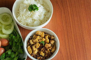 Thai cuisine, Northern of Thailand Lanna style, Hot steamed rice with crispy belly pork in chili flavor and fresh vegetables, space for text