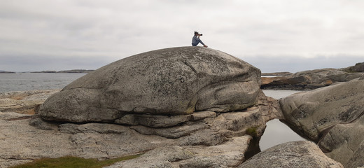 Woman photograph  in The End of the Earth in Norway. Verdens Ende (World's End) is composed of various islets and rocks and is a popular recreational area with fantastic panoramic views. 