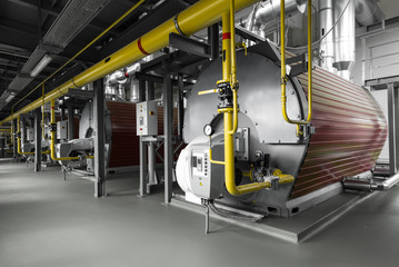 Modern industrial gas boiler room equiped for heating process. Heating gas boilers, pipelines,...