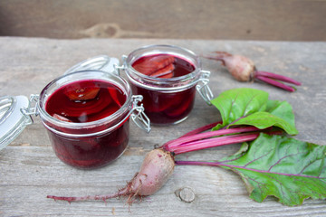 Pickle beets in jars on a background of gray boards