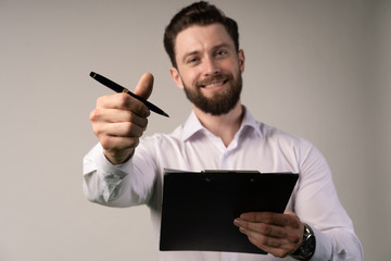 Smiling businessman. Cheers up. Business contract. agreement was signed co-investment business. Giving pen to his partner.