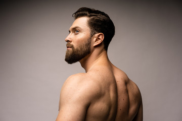 perfect fit man from the back in the white background. Bearded caucasian man.