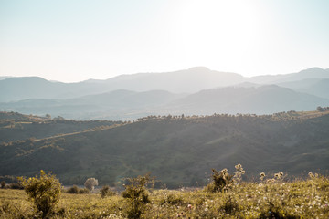 Hills with sun over them.