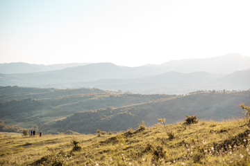 Hills with sun over them.