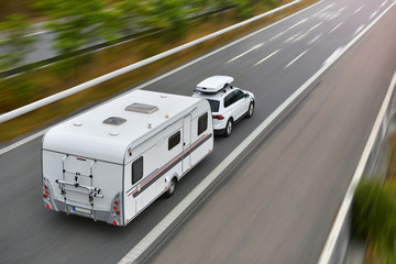 travel on car with caravan trailer by highway - obrazy, fototapety, plakaty