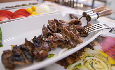Beef meat kebab on the metal skewer.