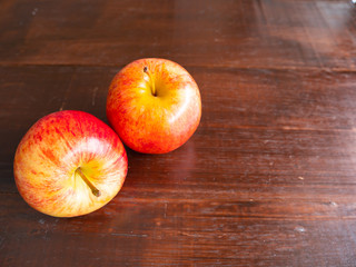 Two apple fruit, on a wooden background.