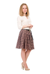 Fashion portrait of a young blonde in a skirt posing in full growth isolated over a white