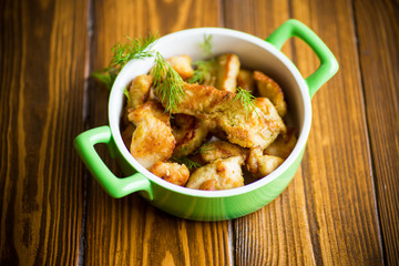 chicken fried in batter with dill on a plate