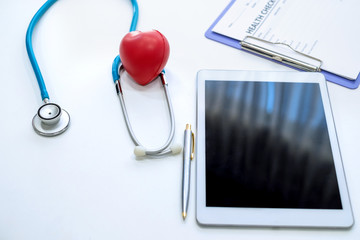 Red heart and stethoscope on the table. Concepts for maintaining health and heart disease.