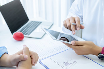 Doctor consultation with the patient by using digital tablet.