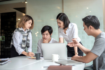 Group of young business people brainstorming at a meeting starting a new business.