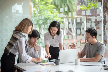 Group of young business people brainstorming at a meeting starting a new business.