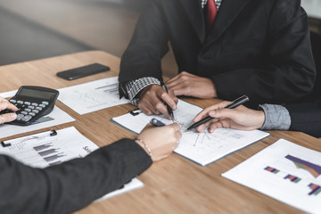 Business people talk about investment, marketing planning and view the data sheet in the financial data graph.