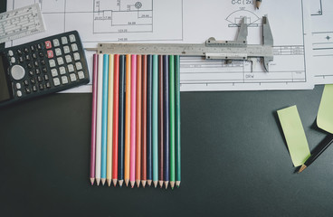 The architect's desk was full of equipment and blueprints. View From Top.