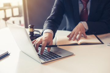 Lawyer using laptop for litigation information in law firms.