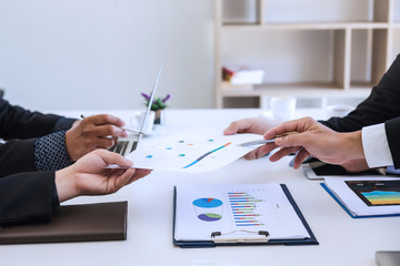 Businessman present graph financial information at the meeting.